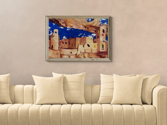 Beige sofa with decorative pillows and a framed surrealist Southwestern pueblo painting on the wall.