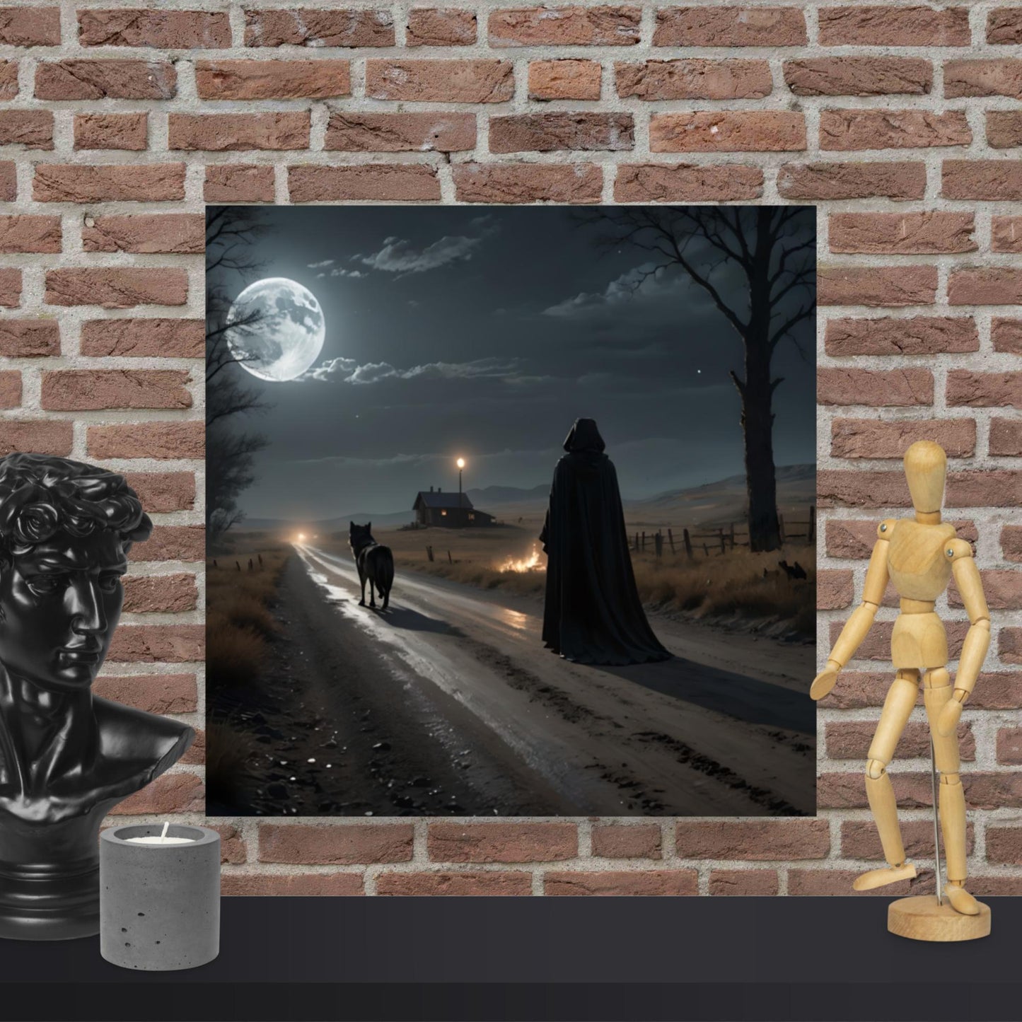 Dark Night of the soul wall art is a moonlit scene with a hooded figure and wolf on a road, displayed against a brick wall with decorative items.