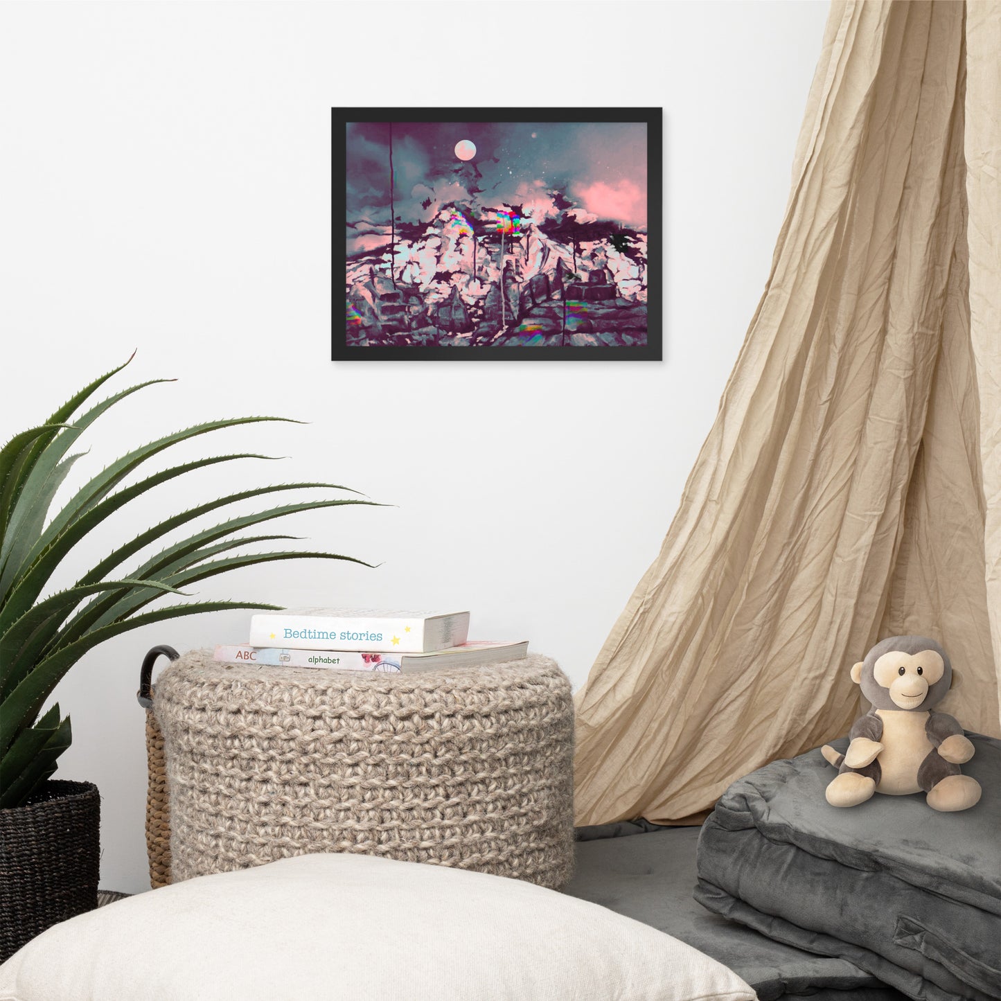 Glitch on Schnebly Road - Surreal digital framed art print showing a rugged mountain range under a cloudy night sky and pale full moon, blending traditional painterly textures with rainbow-colored digital glitch effects. Displayed in Room interior with a a plant, a woven basket, and a plush monkey toy.