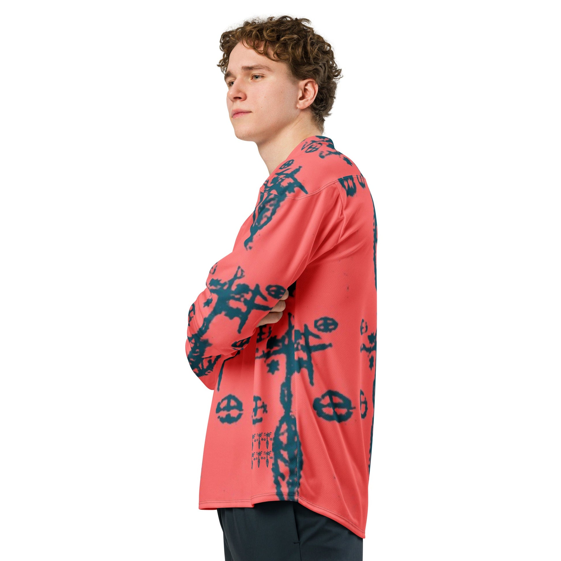Side view of a young man in the recycled hockey fan jersey printed with voodoo symbols.