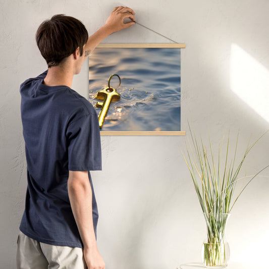 The Golden Key Art Print, inspirational  wall art of a golden key floating on water and a man hanging the print on wooden hangers.